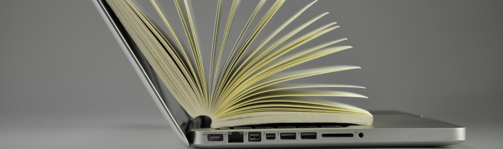 A laptop with alot of pages in between, gray color, Typewiser, AI and Open Science, 